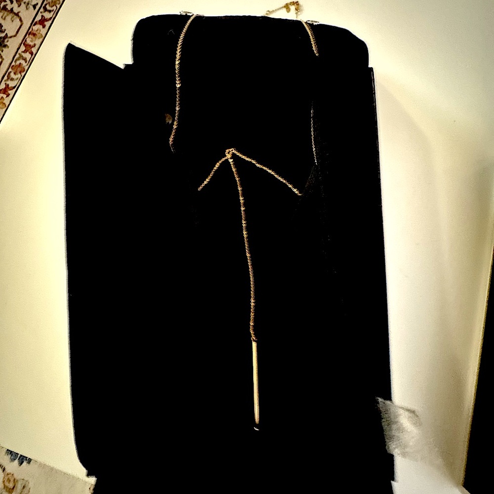 14K Solid Gold bar necklace with a sleek cylindrical shape.